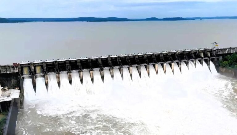 Water rushing out of the open gates of Bargi Dam